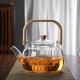 Γυάλινη τσαγιέρα με ξύλινη λαβή και blooming tea σε δίσκο